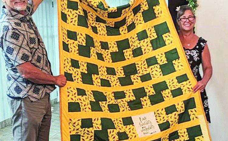 Bubba Jack Mills presented at quilt from the Old Bethel sewing ladies to Bob and Melissa Wallingford in Puerto Rico last week.