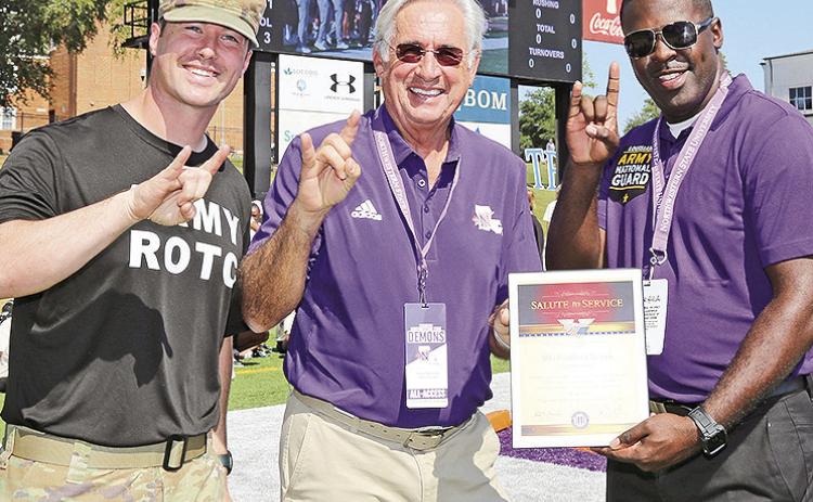 Staff Sgt. Brandon Bullock of Shreveport was honorary captain for Northwestern State University’s Oct. 12 football game. From left are Assistant Professor of Military Science Major Kegan Davis, NSU President James Genovese and Bullock.