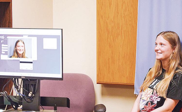 Incoming Northwestern State University student Addison Berg poses for her student identification card photo during registration at NSU’s Shreveport campus.