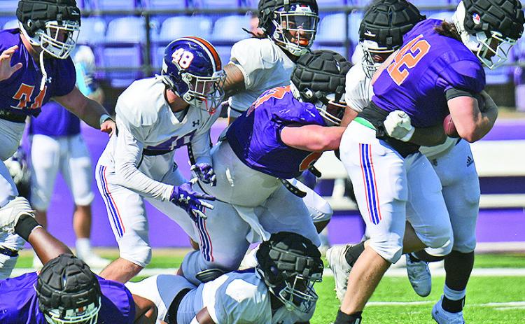Matthew Broad runs through the Northwestern State defense during Saturday’s scrimmage. Photo by Gary Hardamon/NSU Photographic Services