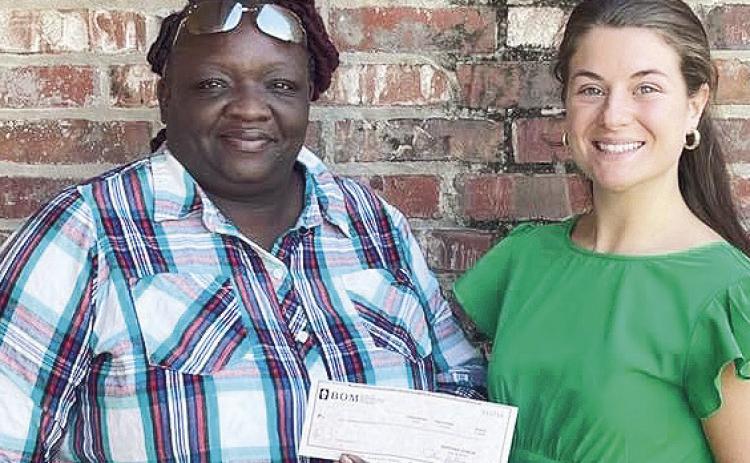 BOM made a donation to Monica Evans to help provide food for the elderly throughout the St. Maurice community during the holidays. From left are Evans and BOM’s Mary Scruggs.