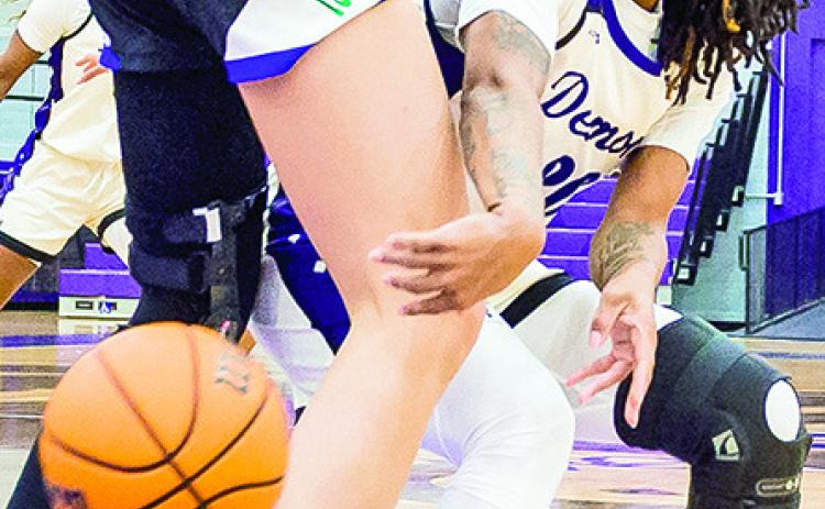 Tiara Abron (right) passes a ball around the defender near the basket. Photo by Chris Reich, NSU Photographic Services