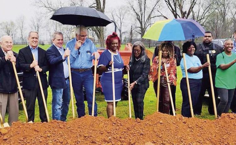 It rained buckets Friday morning but it did not stop the groundbreaking for a new town hall in the Village of Natchez. Among those attending were Natchez resident Tommy Roque, second from left; former Sen. Louie Bernard (fourth from left) who secured money from the State; Parish President John Salter (center in blue shirt); Mayor Patsy Ward Hoover (center in dark blouse); and Natchitoches City Councilperson-at-Large Betty Sawyer Smith. Also attending were members of the Village council among others.