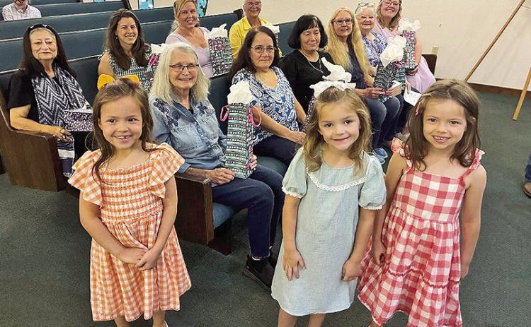 These pretty little misses passed out the Mother's Day gifts at Old Bethel Baptist Church. They are, from left, Rayna Lambert, Maice Smith and Reagan Lambert. Mothers who attended Sunday were, front pew, (front pew), Judy Monett, Jennifer Goleman, Jackie Ford, Linda Byron, Landel Settle and Mackenzie Smith, On second row are Liz Durr, Rhea Lambert, Alicia Raybin and Pam Womack. The picture was part of Liz Durr’s Old Bethel News that can be found on Page 4A.