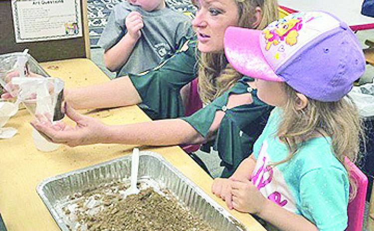 Dr. Debra Jo Hailey worked with children in a Pre-K classroom at Jena Elementary on Dr. Seuss Day.