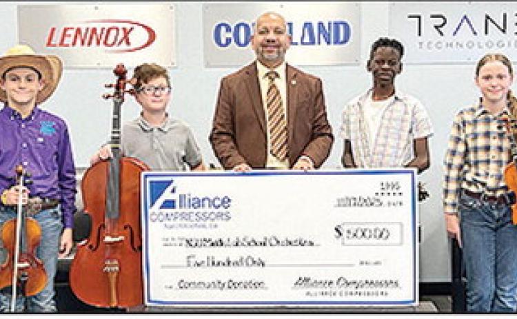 Alliance Compressors donates $500 to NSU Middle Lab Orchestra for the upcoming performance/competition at the Disney Festival in Orlando, FL. From left are students Austin Rachal and Hunter French; Orchestra Director Katrice LaCour and students Micah Williams and Audrey Rachal.