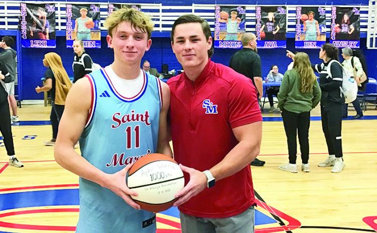Ayden Warren scored his 1,000th career points during the game against Menard. He was recognized during the game for this milestone achievement. At right is Coach Jake Bankston.