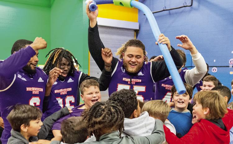Isaiah Ybarra (55) leads a group of NSU football players as they interact with students at NSU Elementary Lab School during Friday’s Chris Waddell Day celebration. Photo by Chris Reich/NSU Photographic Services