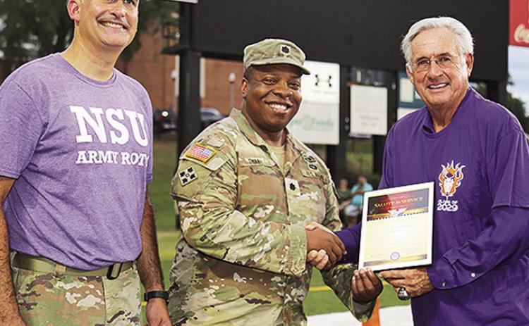LTC Tyrek Swaby was the honorary captain of the NSU’s season opening football game Aug. 28. From left are LTC Josh Drake, Swaby and NSU President James Genovese.