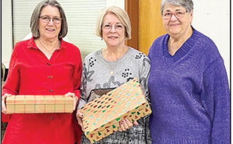 Dottie Mims, left, and Gwen Ponthieux, center were recently recognized by the Natchitoches Catholic Daughters as co-Catholic Daughters of the Year. It was the first time in the history of the local organization’s history that two members each received equal votes for this award. Local Regent, Kathleen Hicks, is shown presenting the two award winners gifts of appreciation for their service to the Catholic Daughters, their churches and the community.