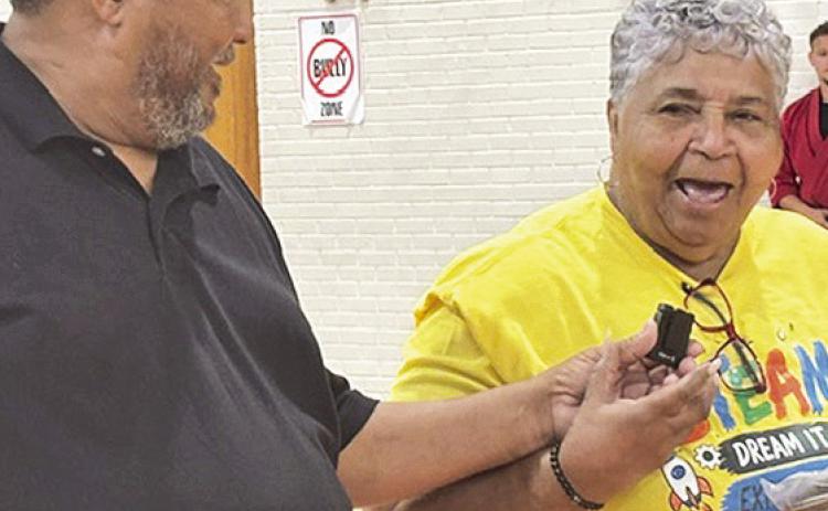 NCIF President Harold Bayonne talks to Camp Director Ernestine Armstrong.