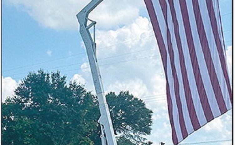 The City of Natchitoches hoists the Red, White and Blue at the foot of Keyser bridge Thursday in honor and remembrance of the 2,977 killed in the terror attacks of September 11, 2001 at the World Trade Center site, near Shanksville, Pennsylvania, and at the Pentagon.