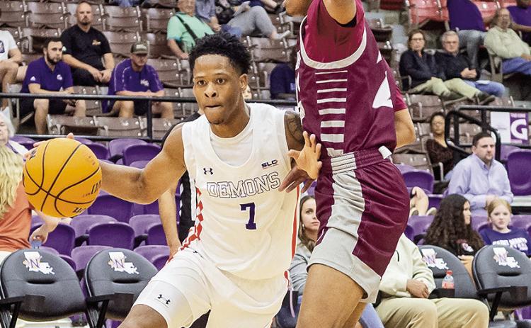 Northwestern State’s Love Bettis (7) drives the baseline against Dallas Christian’s Isaiah Mitchell. Photo by Chris Reich/NSU Photographic Services