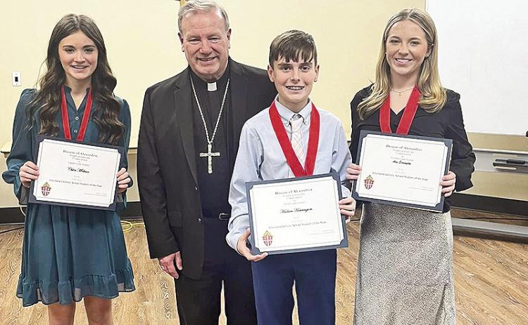 Hudson Harrington, Chloe Methvin and Ava Errington competed for students of the year at the diocesan level competition in Alexandria. Hudson and Ava were named Student of the Year for fifth and 12th grades and will advance to state level competition on Feb. 26 in New Orleans. Chloe received second place honors. From left are are Chloe Methvin, Bishop Robert W. Marshall, Hudson Harrington and Ava Errington.