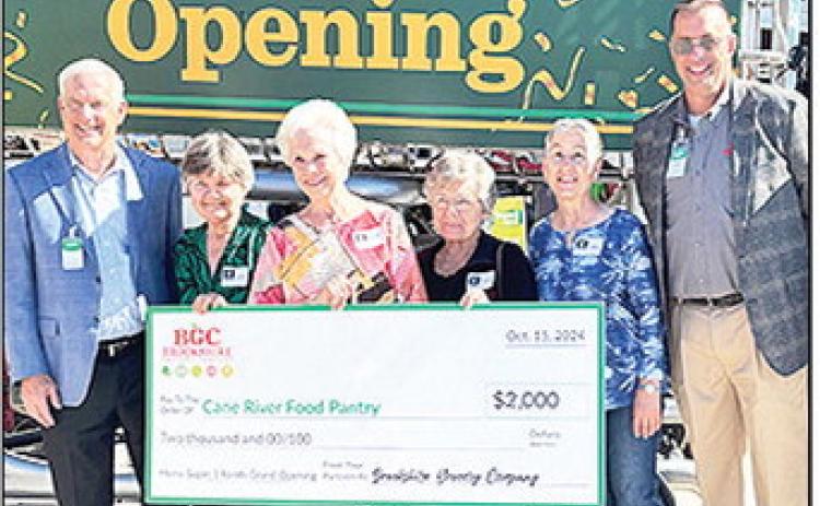 Brookshire Grocery Company donated $2,000 to the Cane River Food Pantry during the Super 1 grand opening. The Cane River Food Pantry distributes foodstuffs the second Saturday of the month from 8 to 10 a.m. at 446 Martin Luther King Dr. to qualifying persons. To apply or to drop off donations go to the pantry office at 220 Amulet St. At left is Chairman/CEO Brad Brookshire, and at right is Store Director Eddie Medley.