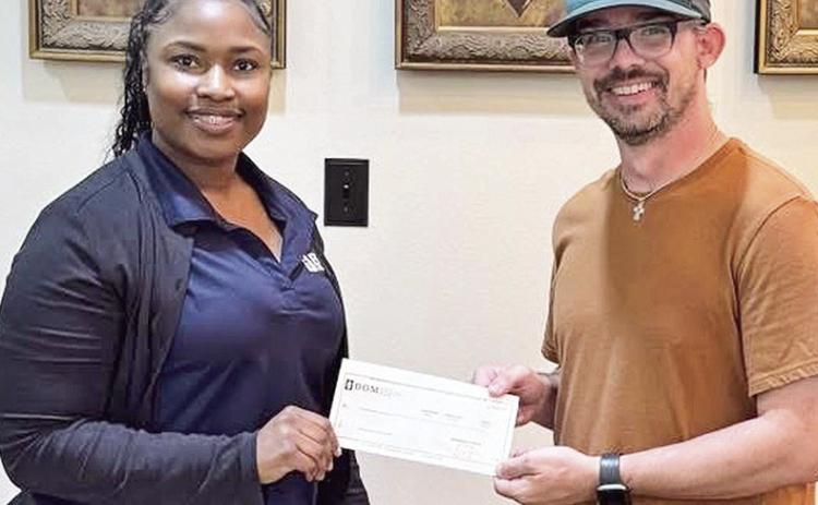 BOM made a donation to the Lakeview High School softball program. Pictured from the left are BOM’s Shonterika Payton and LHS Head Coach Blake Dodson.