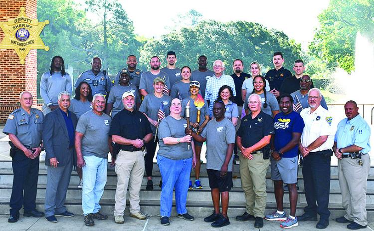 Those who were in the Special Olympics Torch Run met on the riverbank for a prayer to remember fallen officers.