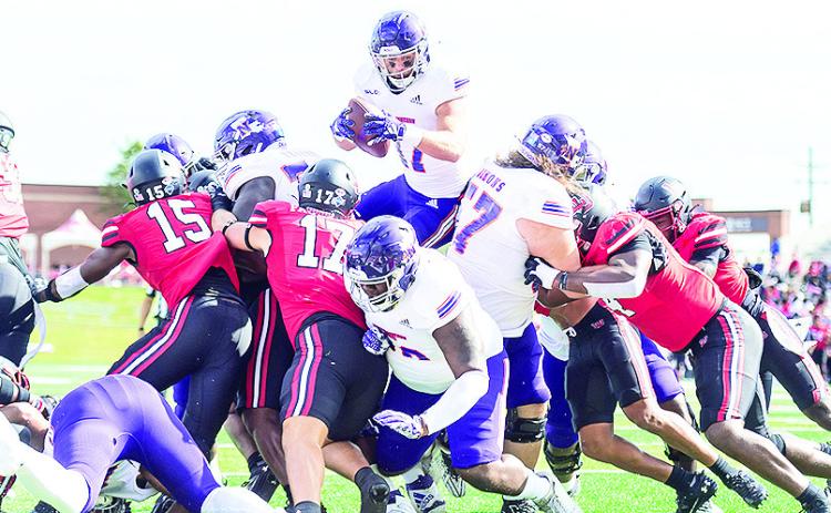 Chance Newman leaps for a touchdown during Saturday’s game at Lamar. Photo by Chris Reich/NSU Photographic Services