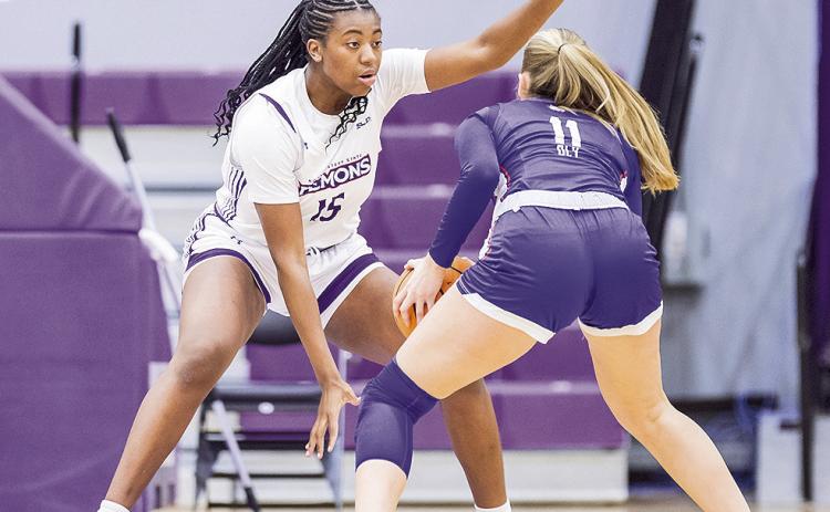 Clarence Djuela (15-white) sets her defensive stance. Photo by Chris Reich, NSU Photographic Services