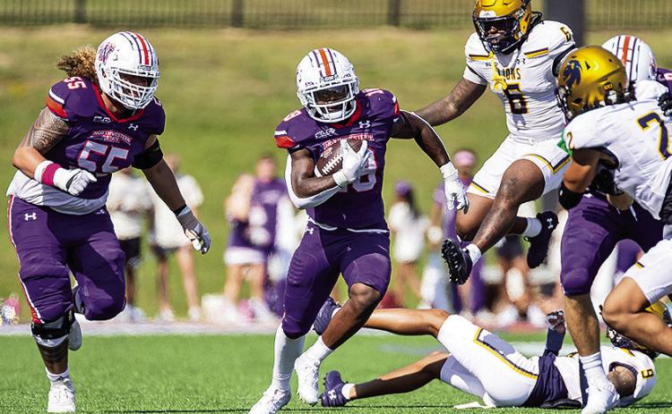 Northwestern State’s Zay Davis (center) cuts upfield during the Demons’ Oct. 12 game against Texas A&amp;M-Commerce. Photo by Chris Reich/NSU Photographic Services