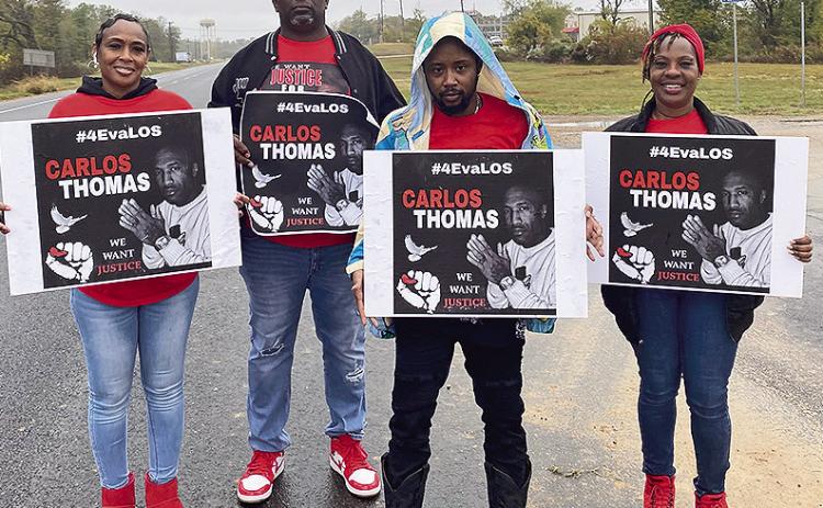 Family and friends of the late Carlos Thomas hold a peaceful; protest at the Detention Center Friday, Nov. 10. Thomas died suddenly last year while he was in custody. Pictured from the left are Shameka Thomas, David George, Jay Knott, and Twana Manning.
