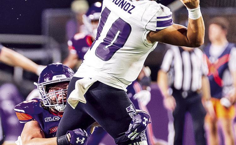 Blake Gotcher sacks Weber State quarterback Richie Munoz on Sept. 21. Photo by Chris Reich/NSU Photographic Services