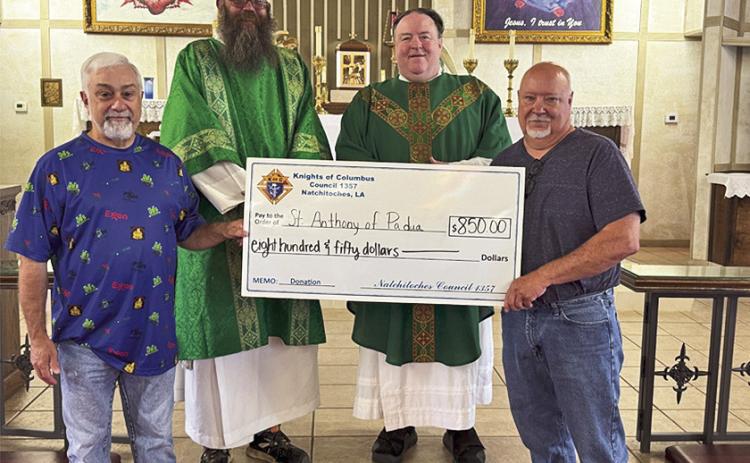 Knights present a check to St. Anthony Catholic Church. From left are John Abraham, Deacon Steven Newbury, Father John O’Brien, and Mike Scott.