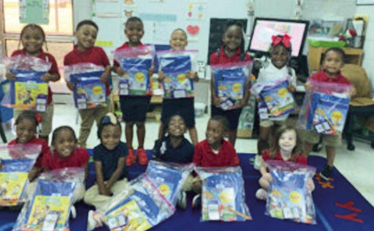 Students in Chelsi Ortiz’s class to receive literacy bags are , front row from left, Aeisha George, Trinity Johnson, Nyla Dorsey, Ma’Kyia Easley, Avery Gordon and Sara Austin. On the back row are Kayleigh Jefferson, Tyrease Brown, Kingston Jackson, King Triggs, Zoey Shelvin, Skylar Moore and Keegan Joseph.