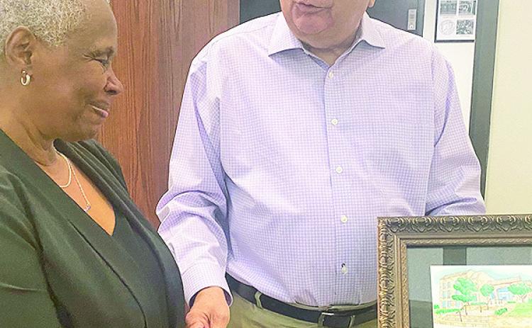 The Library Board of Control board presented a plaque to Gloria Waldrup-Davis for her service to the library. Replacing Waldrup-Davis, who retired, is Barbara Smith. Board President Tommy Roque presented the plaque. See Library Story Page 2A