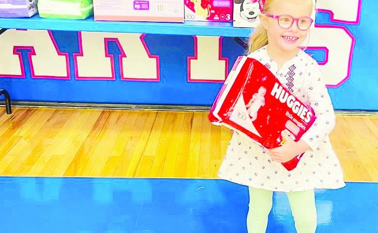 St Mary’s Amy Poston is all smiles as she donates diapers to the Women’s Resource Center during National Catholic School Week, an annual celebration that recognizes service to others. Other themes were celebrating families; students; staff, and faculty; our nation and community.