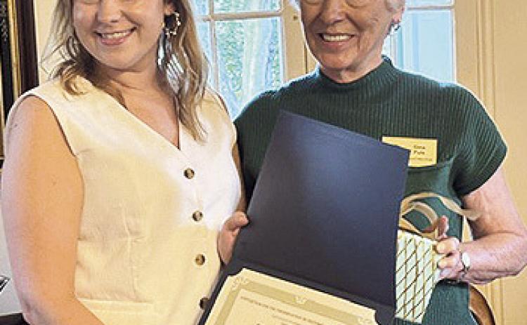 Members of the Association for the Preservation of Historic Natchitoches held their “White Linen Night Membership Appreciation” Aug. 21 at the Lemee House during a garden party. Board President Gina Puls presented appreciation awards to two women for their outstanding service to APHN. In photo at left, Pulls presents a certificate to Erica Outlaw, director of the Calico Belles, that is for girls in seventh through 12th grades who act as junior hostesses. In photo at right, Puls recognizes Alma Alost who was