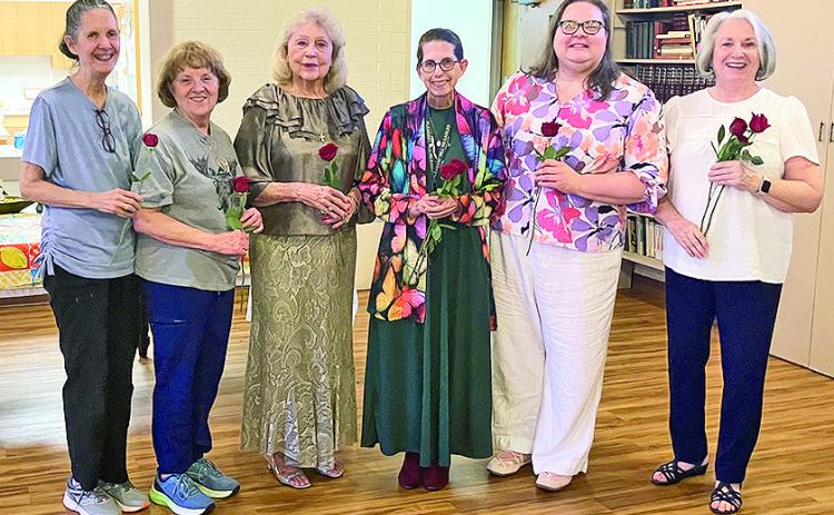 Receiving red roses were, from left, Mary Squyres, Susan Massia, Dianne Alexander, Gilen Norwood, Donna Baker and Janine Storrs after the installation of officers.