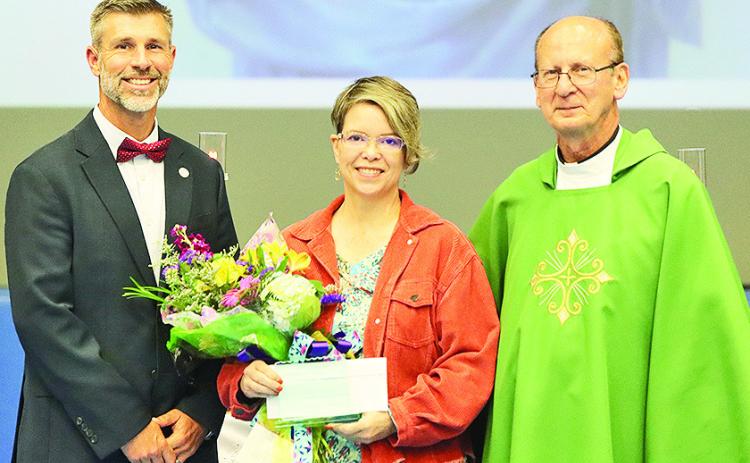 From left are Principal Stephen Wren, Donnan Brian and Chancellor Fr. Irion St. Romain.