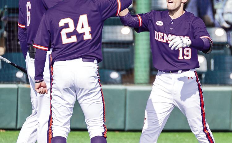 Rocco Gump (left) and Reese Lipoma (24) congratulate Samuel Stephenson after Stephenson homered last weekend’s series finale against Central Arkansas. Photo by Chris Reich/NSU Photographic Services