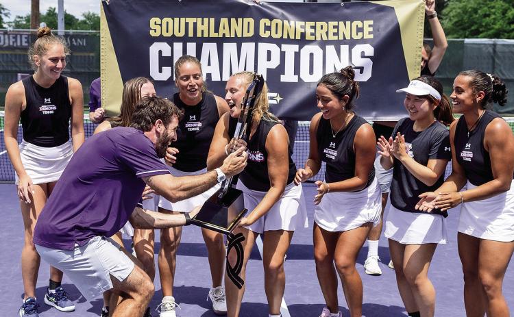 Head coach Marcos Morelli celebrates with the Lady Demons as they clinched the regular season SLC title on Monday following a 4-3 victory over Southeastern. Photo by Chris Reich, NSU Photographic Services