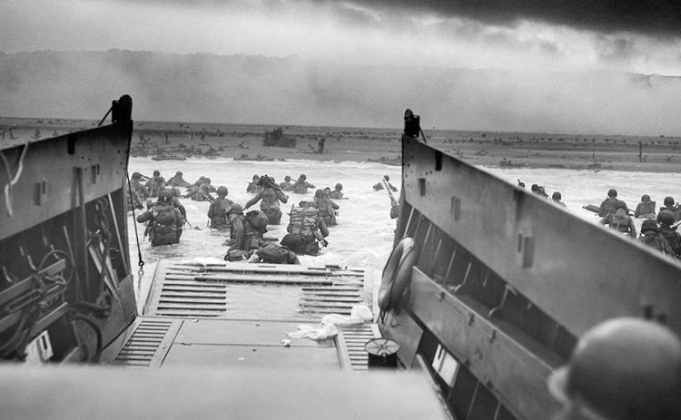 A Coast Guard Higgins boat lands troops assigned to the 1st Infantry Division onto Omaha Beach, Normandy, France, on D-Day, June 6, 1944. The Coast Guard marks its 235th birthday Aug. 4, 2025 Photo by Coast Guard Chief Robert F. Sargent