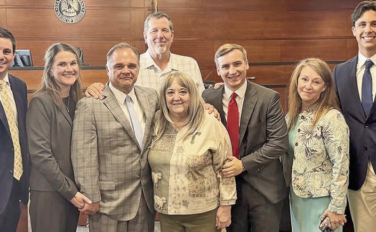 Her legal team joined Pamela Lockridge the day a Bossier Parish jury returned a verdict of more than $1 billion. From left are Stephen Cox, Susan Gatti, Ryan Gatti, Mark Lockridge (back), Pamela Lockridge, Nikolas Roudkovski, Stefanie Phillips and Whitman Johnson.