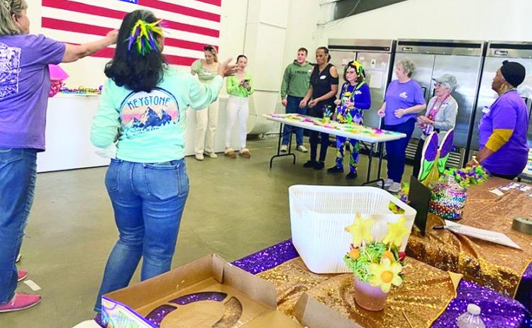 The group played games at the Mardi Gras party.