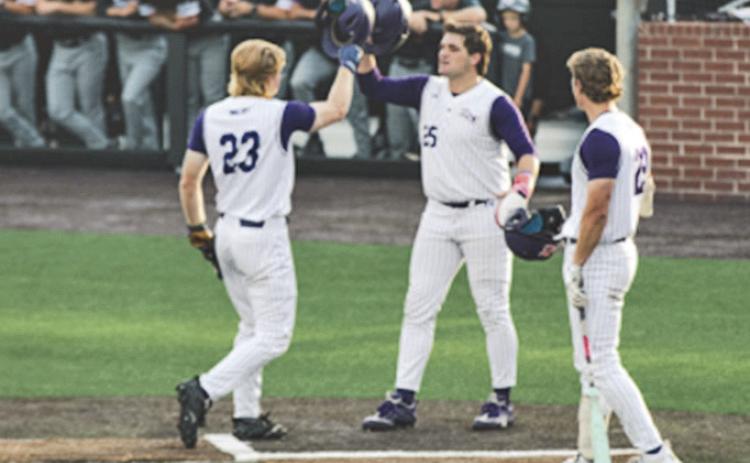 Joe Siervo (left) gets congratulated by teammate Ethan Menard following Siervo's two-run home run earlier in the tournament.