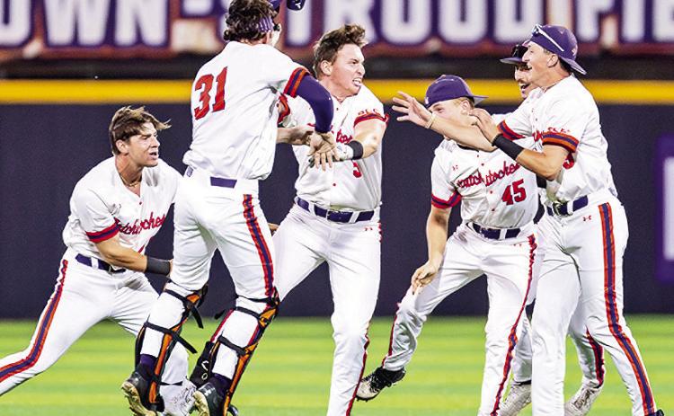 Clay Jung (center) is mobbed by teammates after Jung’s RBI double gave Northwestern State a 10-inning win against Lamar on Friday night. Photo by Chris Reich/NSU Photographic Services