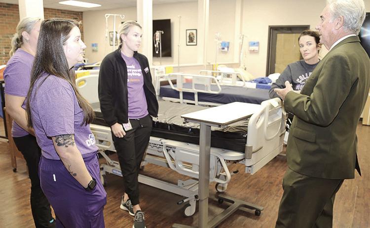 Northwestern State University President James Genovese toured nursing labs at the university’s Leesville campus reentry and spoke with students, from left, Kathryn Whitesides (partially hidden), Katie Palma, Jessica Mendoza and Kelly Mendoza. It was the president’s first tour of the campus, which serves both the military population at Fort Johnson as well as the civilian population in Vernon, Beauregard and Sabine parishes.