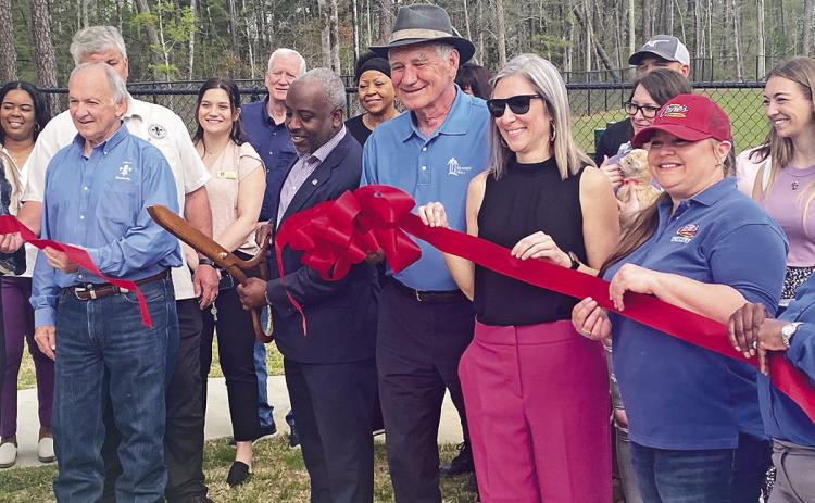 Mayor Ronnie Williams, Jr. cuts the ribbon Thursday morning to commemorate the grand opening of the dog park at PARC Natchitoches. Among the dignitaries on hand for the ceremony were District 2 City Councilman Dale Nielson, District 3 Parish Councilman Wayne Halm, Parks &amp; Rec Director Kevin Warner, and City Community Development Director Randy LaCaze.