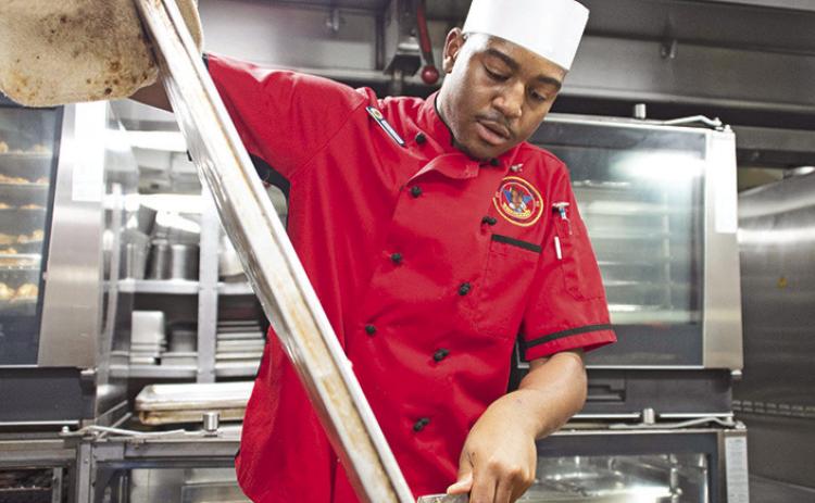 Culinary Specialist 3rd Class Diekentrich Malone, a native of Mansfield, prepares dinner aboard Nimitz-class aircraft carrier USS Carl Vinson (CVN 70). Vinson, flagship of Carrier Strike Group One , is deployed to the U.S. 7th Fleet area of operations in support of a free and open Indo-Pacific. U.S. Navy photo by Mass Communication Specialist Seaman Nathan Jordan