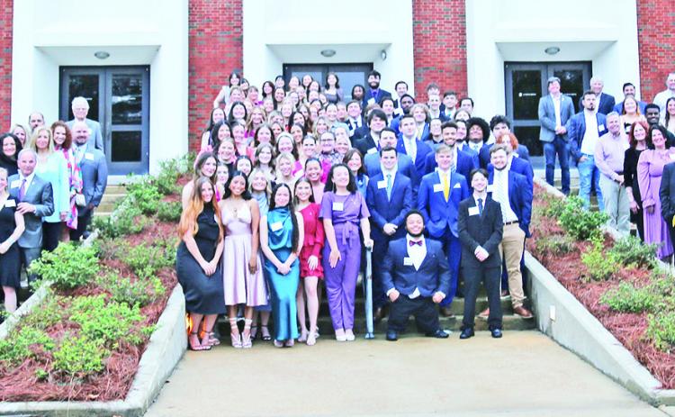Members of Sigma Sigma Sigma Sorority and Pi Kappa Phi Fraternity, along with parents, friends and supporters, are pictured with David and Sherry Morgan prior to the Morgan Extra Mile Scholarship program March 4.