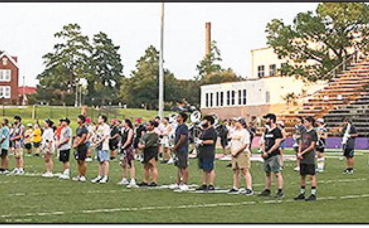 The Demon Marching Band runs drills in perfect formation.