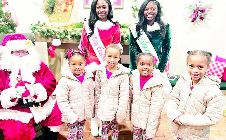 Christmas Day has passed but The Natchitoches Times wanted to share this photo with Santa. Miss Merry Christmas Layla Nicole Johnson and Christmas Belle Ayla Payne helped surprise four beautiful little girls with a visit from their favorite elf —Trixie Blitz—at the Santa House. From the left are Leah, Isabella, Claire and Abigail LaCour.