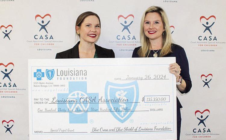 Chloe Wiley, initiatives manager at The Blue Cross and Blue Shield of Louisiana Foundation, presents the check to Amanda Moody, executive director at Louisiana CASA.