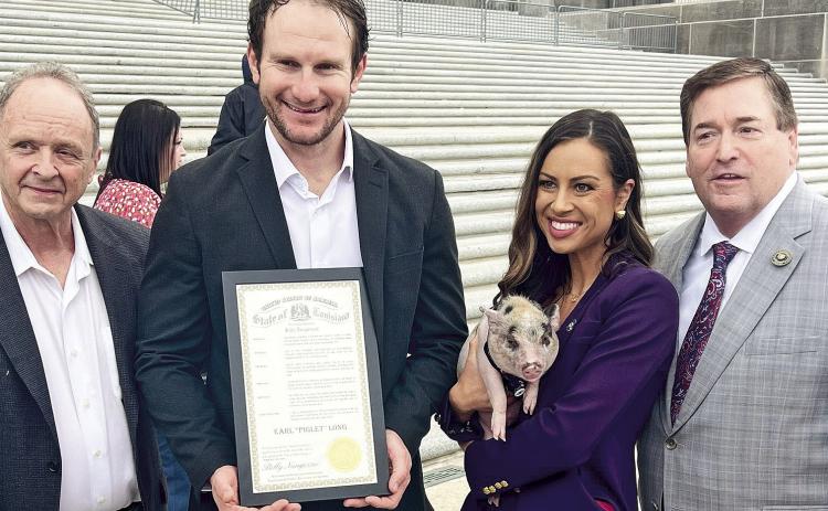 Lt. Gov. Billy Nungesser (at far right) is joined by Humane Society of Louisiana Director Jeff Dorsan, Rep. Ventrella’s husband Adam Brister, and Representative Lauren Ventrella following the lieutenant governor’s official pardon being bestowed upon Earl “Piglet” Long.