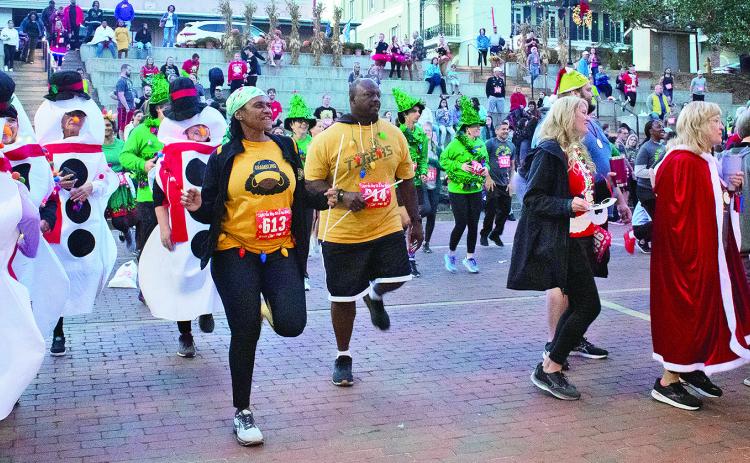 Last year’s participants, dressed in their Christmas best, gather on the Downtown Riverbank for the annual Light the Way 5K &amp; Fun Run hosted y the Natchitoches Young Professionals, an arm of the Natchitoches Area Chamber of Commerce.
