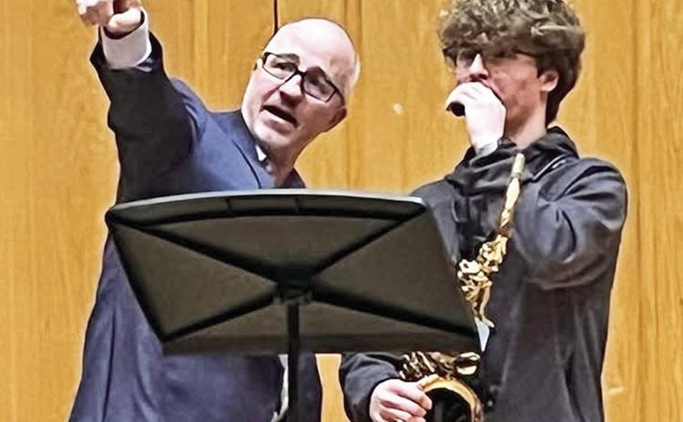 Eric Lau instructs Davis Guidry from Dutchtown High School. Lau is a member of the Iridium Quartet.
